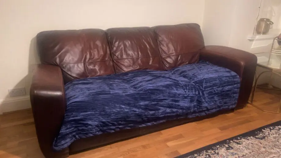 Set of two real leather three-seater sofas with stool