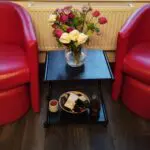 2 x Red armchairs with 2 foot stools. Great offer
