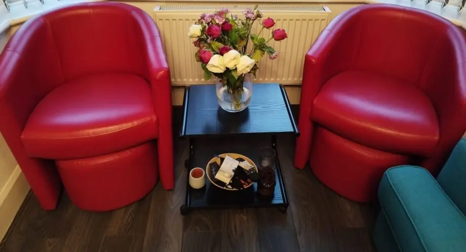 2 x Red armchairs with 2 foot stools. Great offer