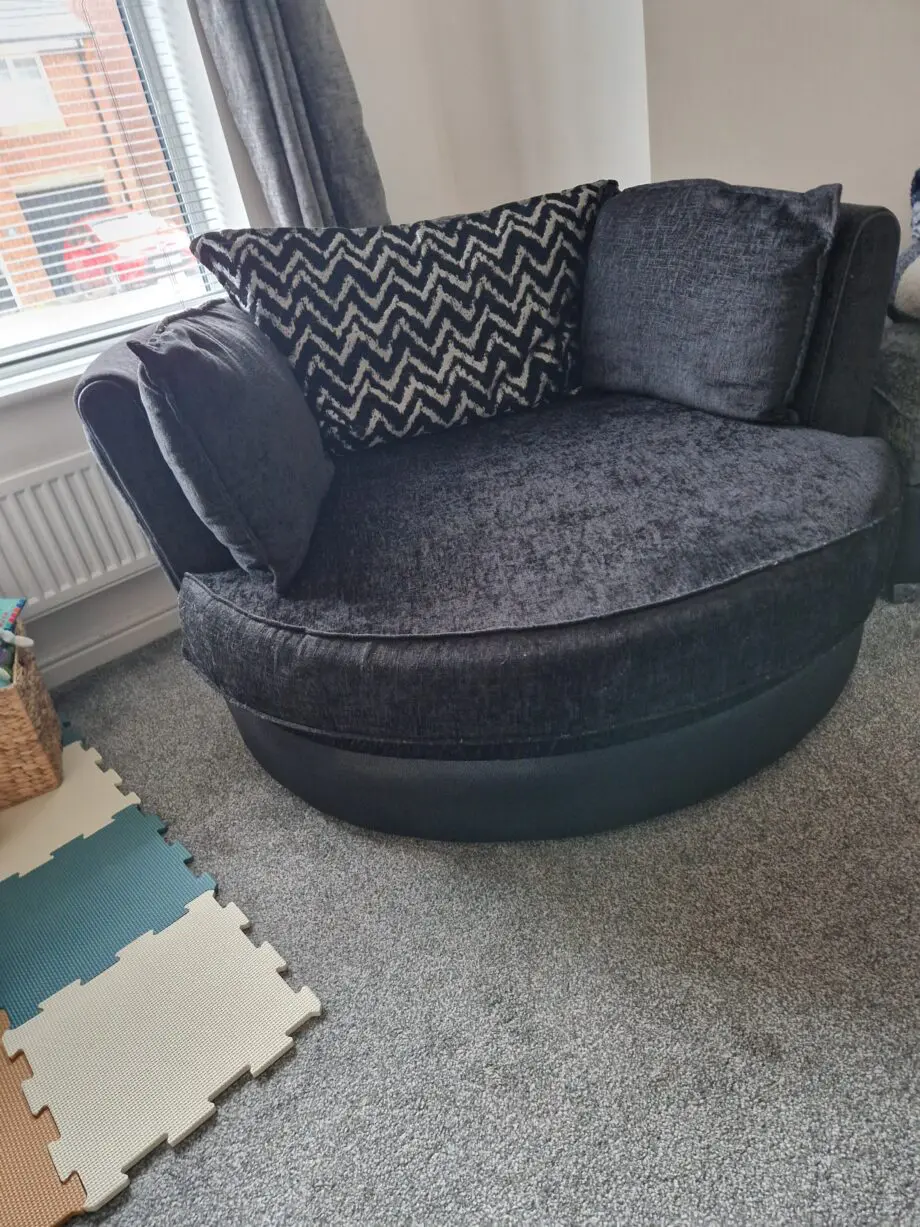 DFS OLLIE large swivel chair in black and charcoal combination.
