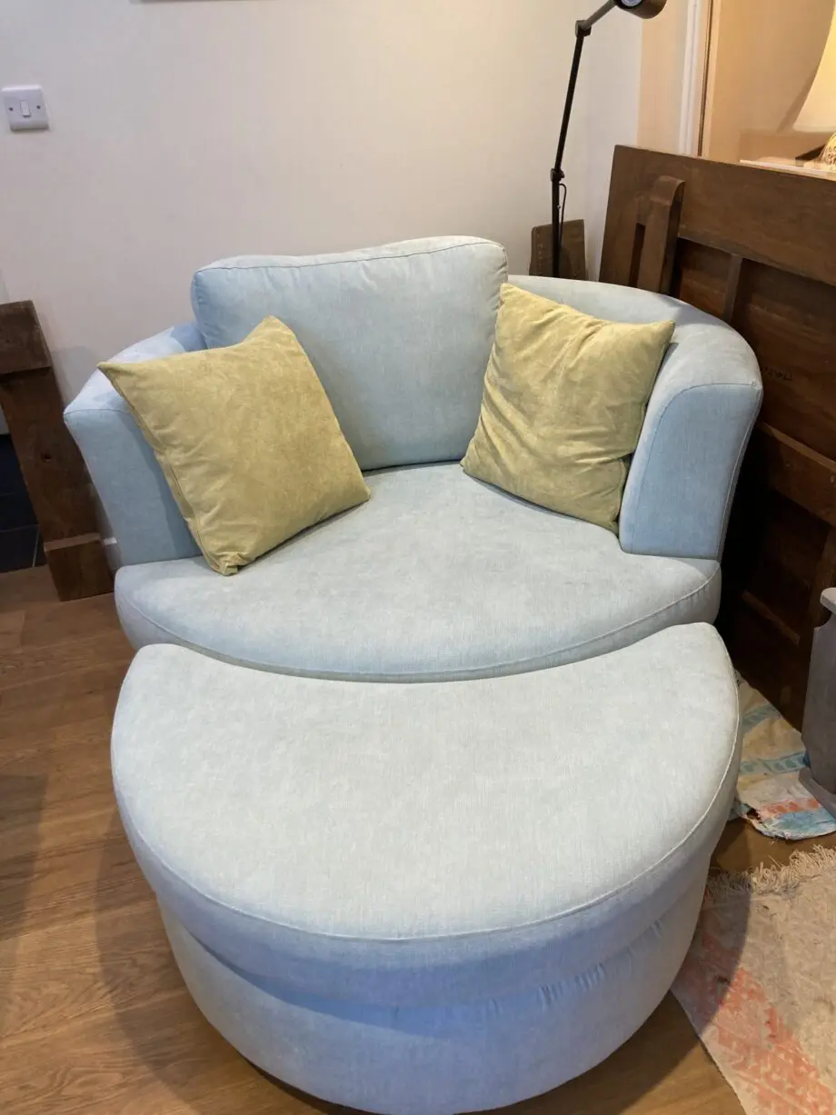 Blue swivel love seat with wraparound foot rest