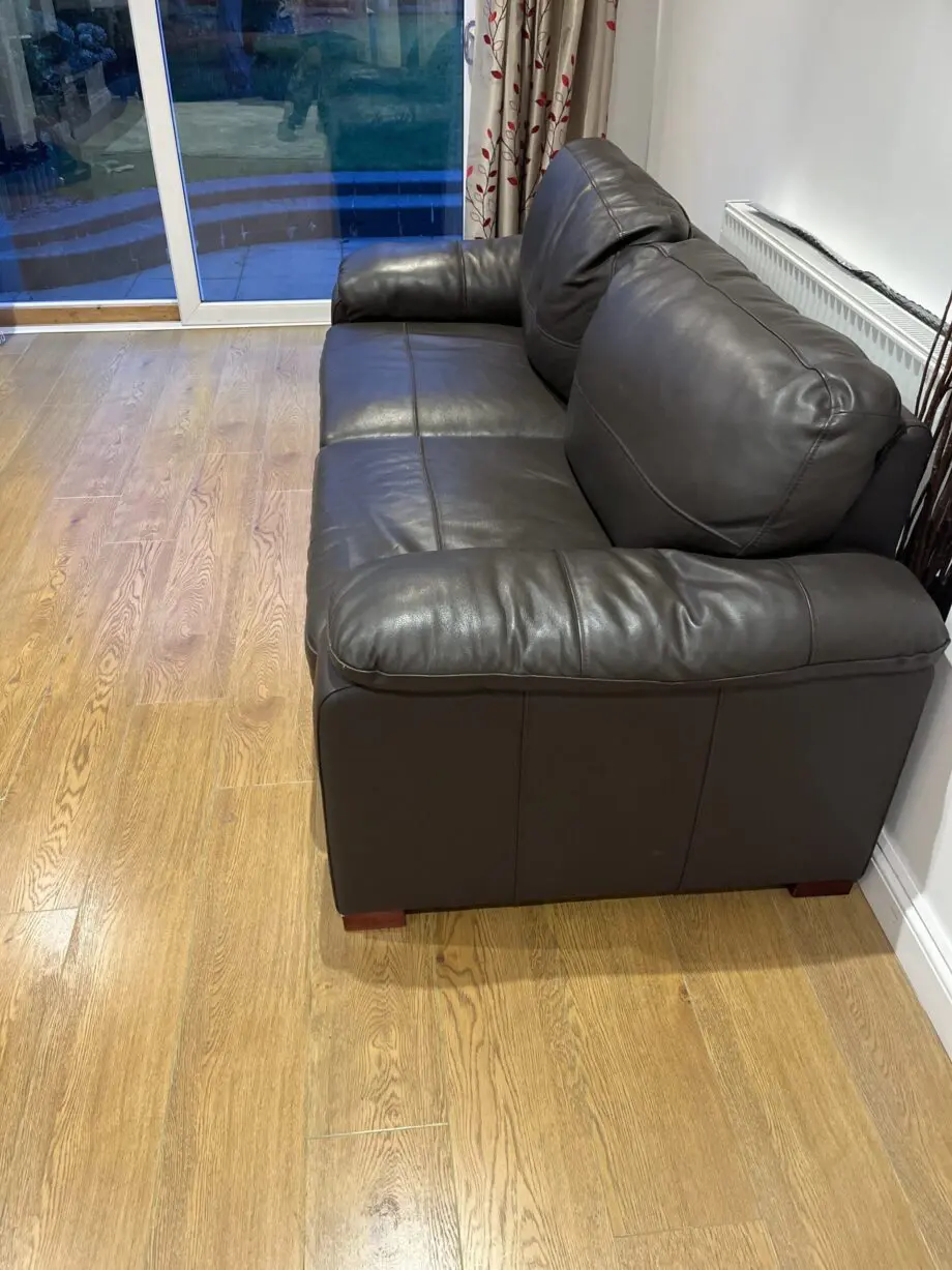 Two leather brown three seater sofas