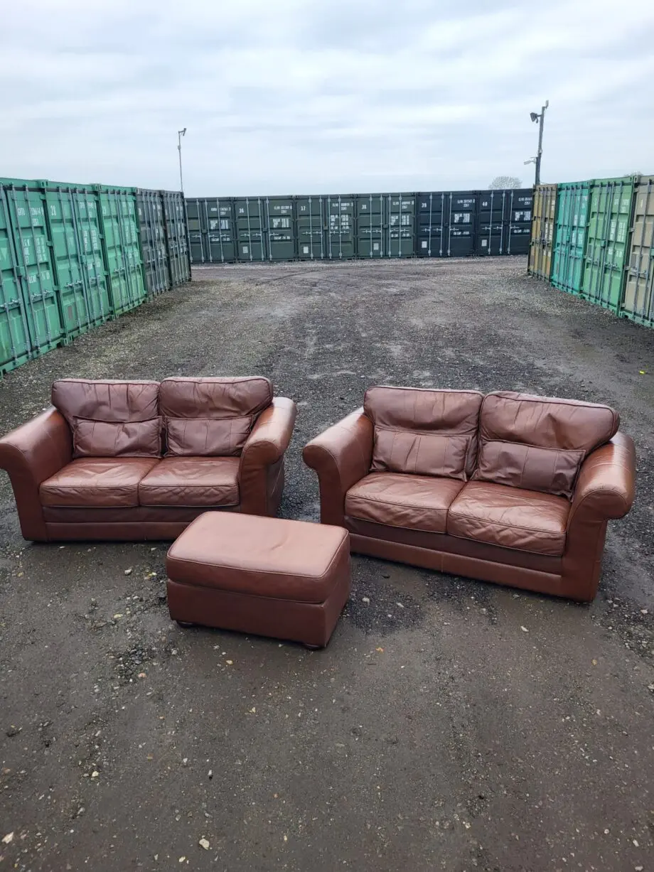 Two Brown Two-Seater Sofas & Footstool