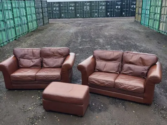 Two Brown Two-Seater Sofas & Footstool