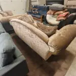 Beige/brown chesterfield sofas.