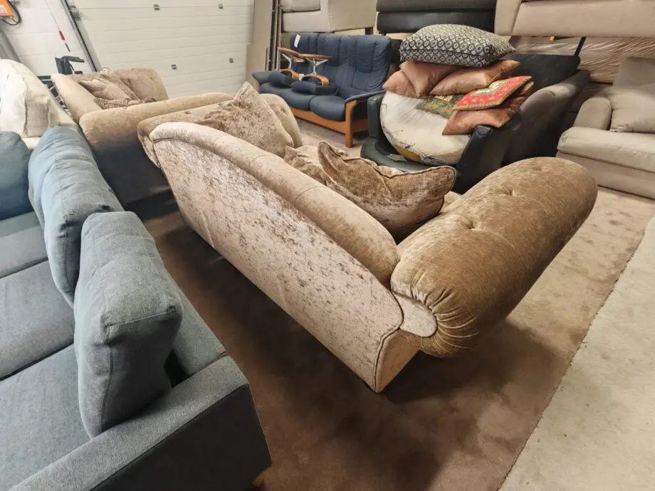 Beige/brown chesterfield sofas.