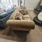 Beige/brown chesterfield sofas.