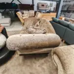 Beige/brown chesterfield sofas.