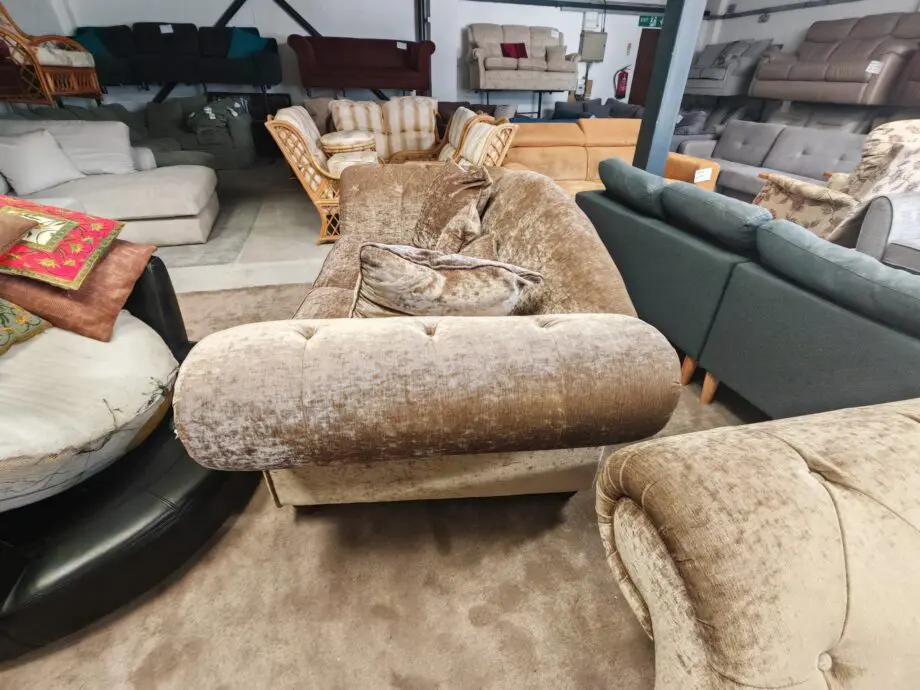 Beige/brown chesterfield sofas.