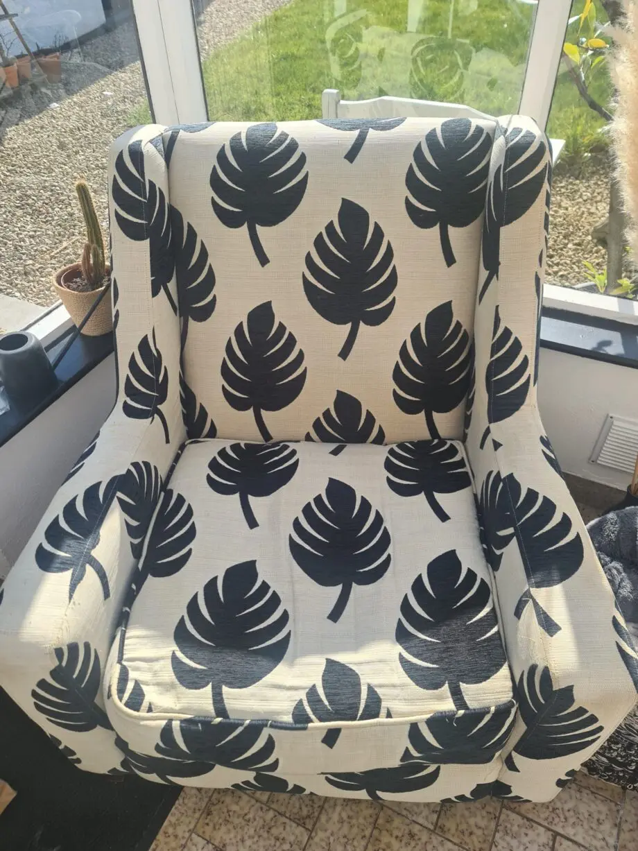 DFS Black and neutral palm leaf pattern fabric armchair and matching footstool