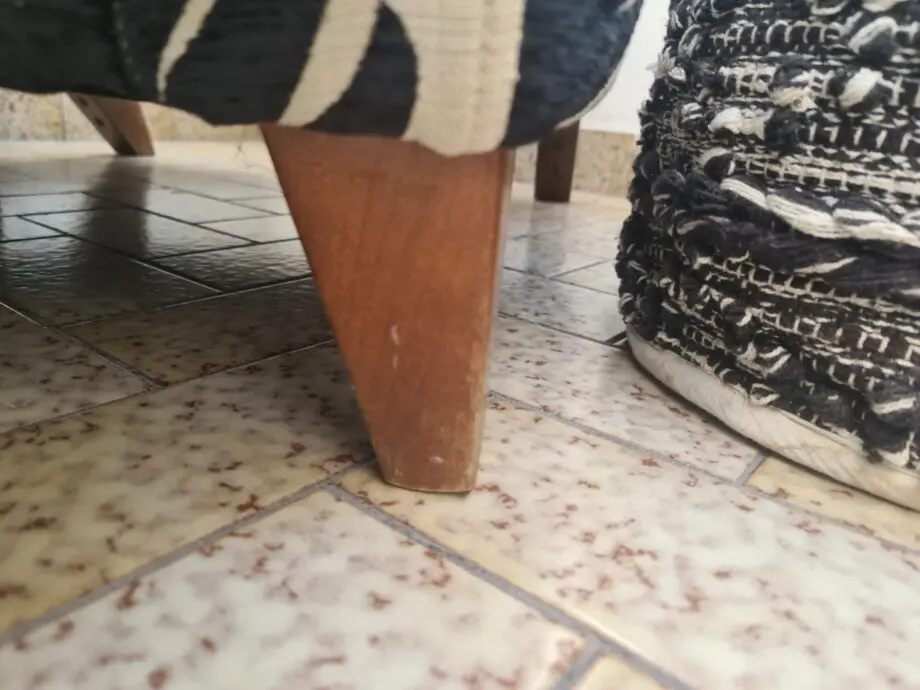 DFS Black and neutral palm leaf pattern fabric armchair and matching footstool