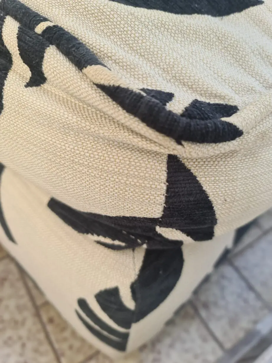 DFS Black and neutral palm leaf pattern fabric armchair and matching footstool