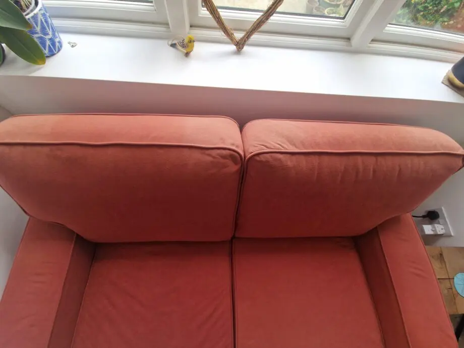 Two lovely matching comfy rust/orange sofas
