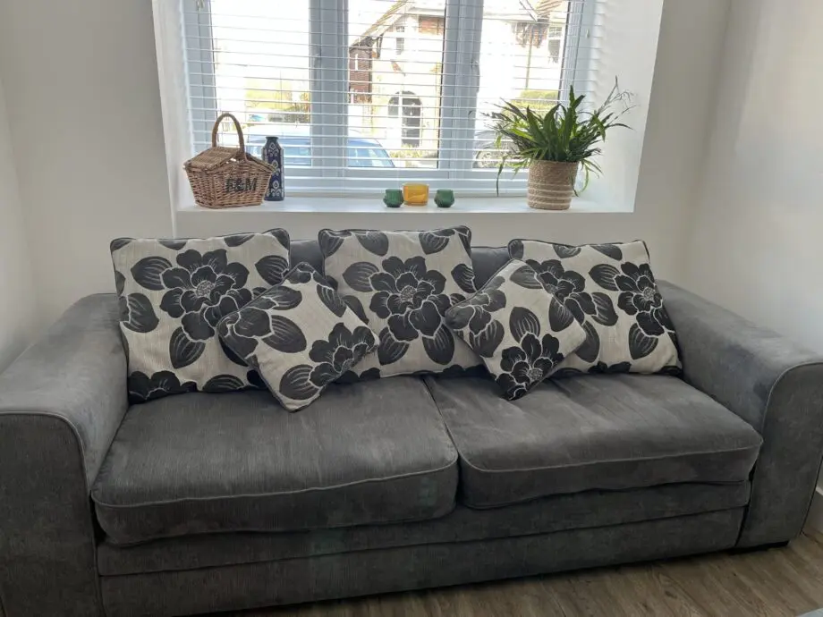 Dark Grey sofa with cushions and large footstool