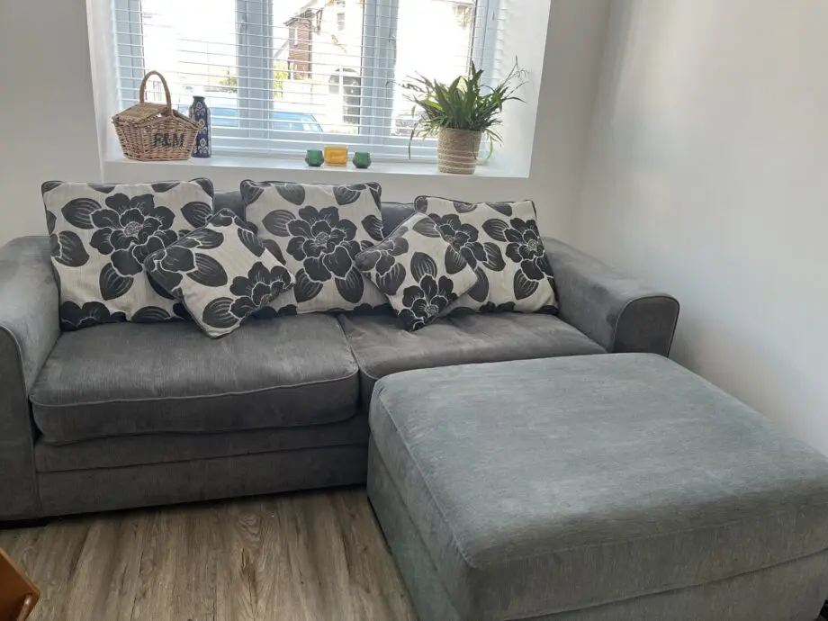 Dark Grey sofa with cushions and large footstool