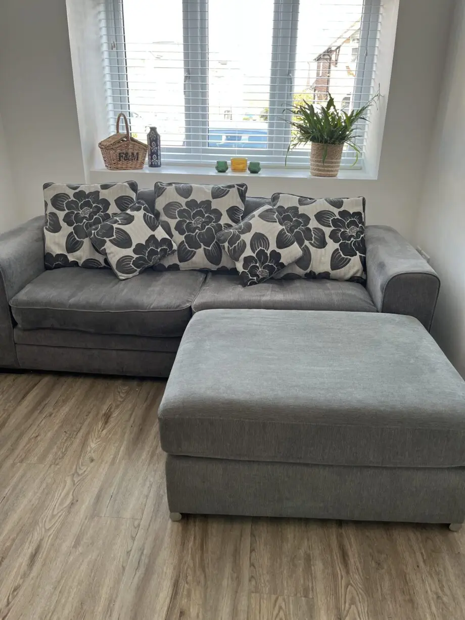 Dark Grey sofa with cushions and large footstool