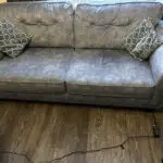Paisley grey studded sofas and Banquet foot stall