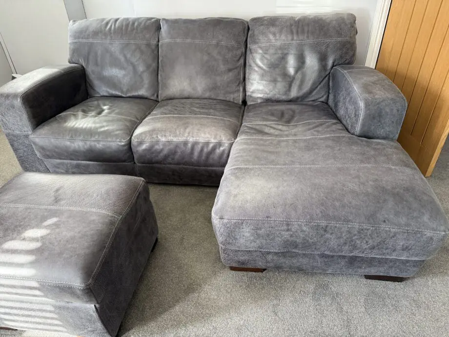 DFS Grey leather Caesar corner sofa and footstool