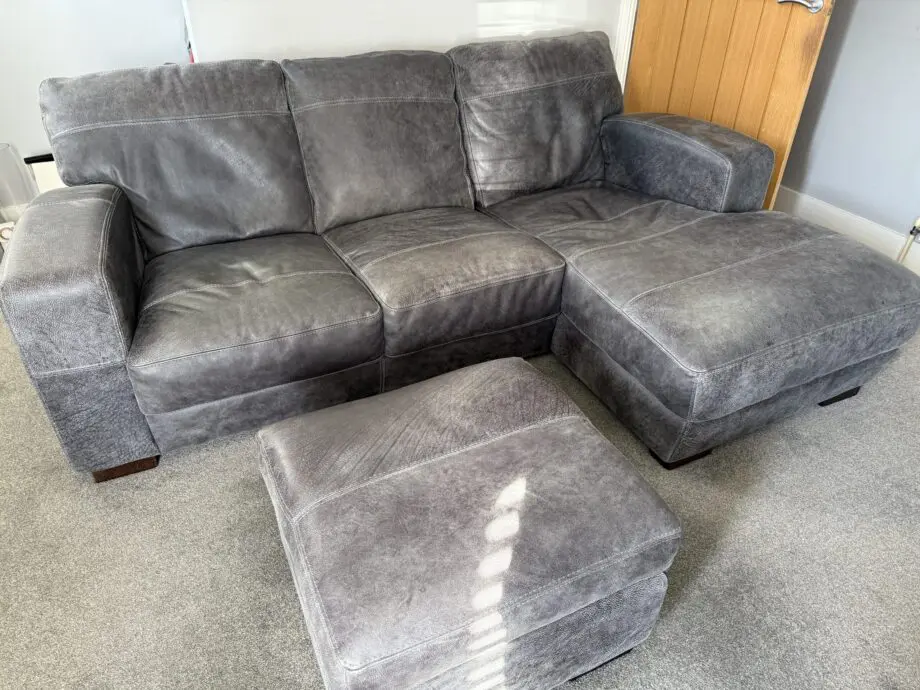 DFS Grey leather Caesar corner sofa and footstool