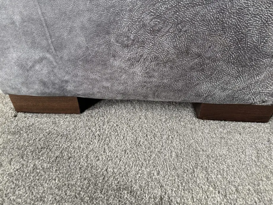 DFS Grey leather Caesar corner sofa and footstool