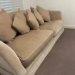 Parker knoll two seater (large) velvet sofa with the colour of a warm beige with pink tone.