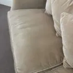 Parker knoll two seater (large) velvet sofa with the colour of a warm beige with pink tone.