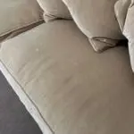 Parker knoll two seater (large) velvet sofa with the colour of a warm beige with pink tone.