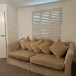 Parker knoll two seater (large) velvet sofa with the colour of a warm beige with pink tone.