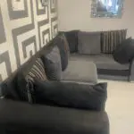 Grey and black corner sofa and round swivel chair