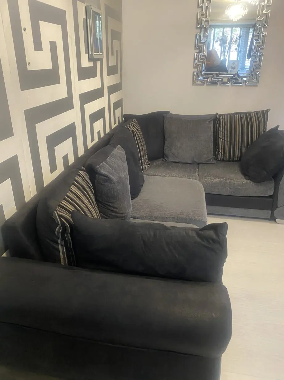 Grey and black corner sofa and round swivel chair
