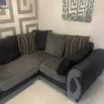 Grey and black corner sofa and round swivel chair