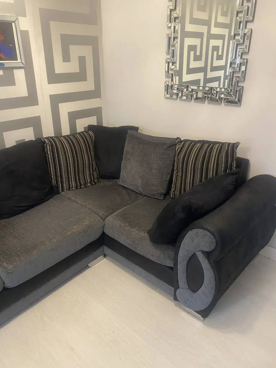 Grey and black corner sofa and round swivel chair