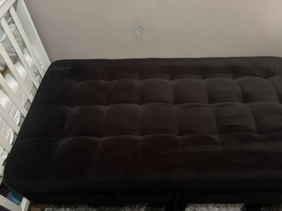 Black sofa bed with pouffe