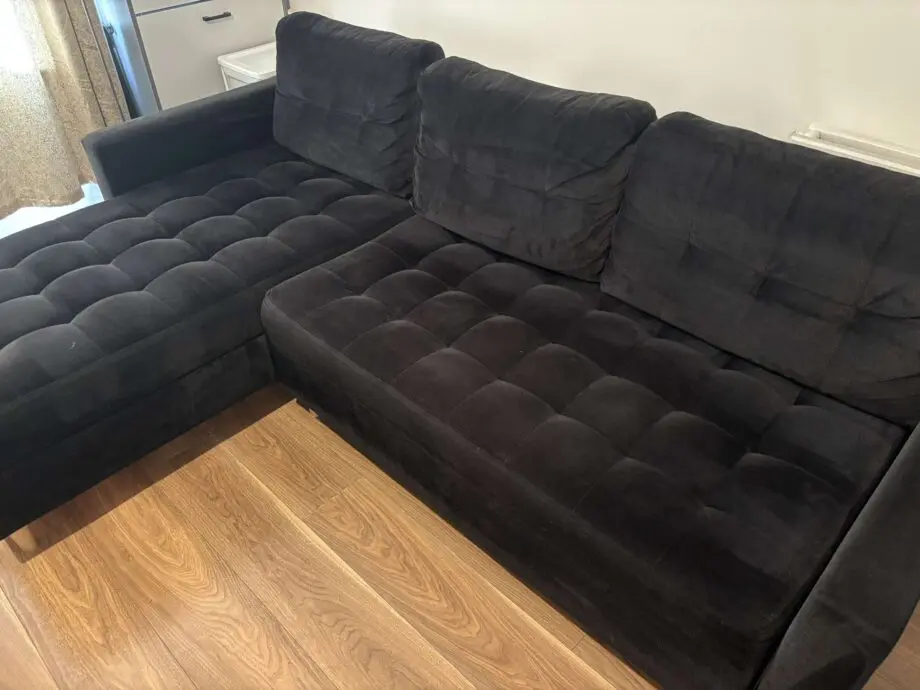 Black sofa bed with pouffe