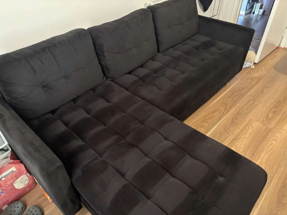 Black sofa bed with pouffe