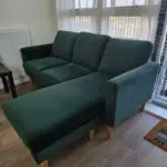 L shaped emerald green sofa