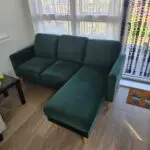 L shaped emerald green sofa