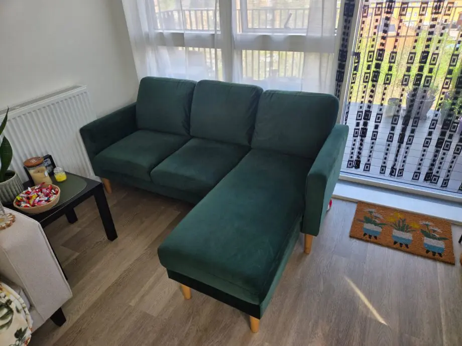 L shaped emerald green sofa