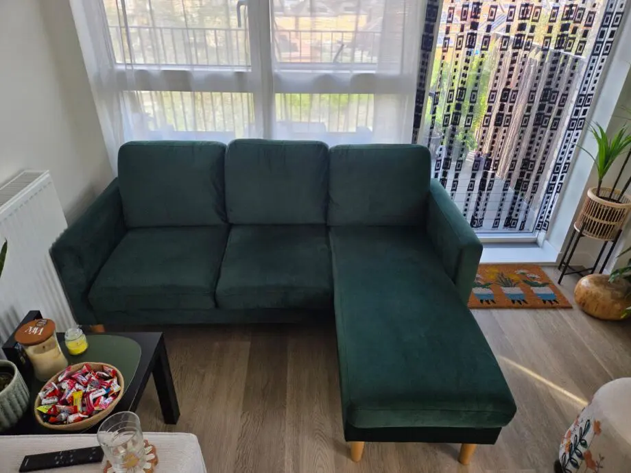 L shaped emerald green sofa