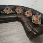 Harveys Brown Leathaire corner Sofa. Two ends recline (1 electric, 1 manual). Incl footstool storage.