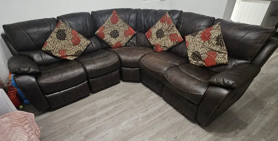 Harveys Brown Leathaire corner Sofa. Two ends recline (1 electric, 1 manual). Incl footstool storage.