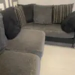 Grey and black corner sofa and round swivel chair