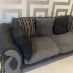 Grey and black corner sofa and round swivel chair