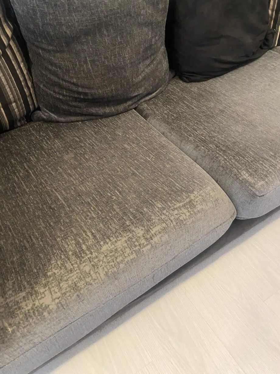 Grey and black corner sofa and round swivel chair