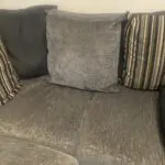 Grey and black corner sofa and round swivel chair