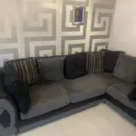 Grey and black corner sofa and round swivel chair
