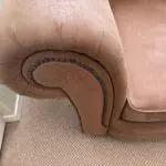 Tan leather effect cuddle chair.