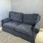 Deep blue sofa bed with footstool