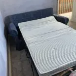 Deep blue sofa bed with footstool