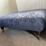 Deep blue sofa bed with footstool